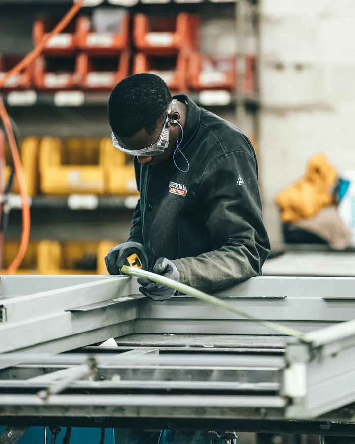 Skilled worker measuring a metal frame