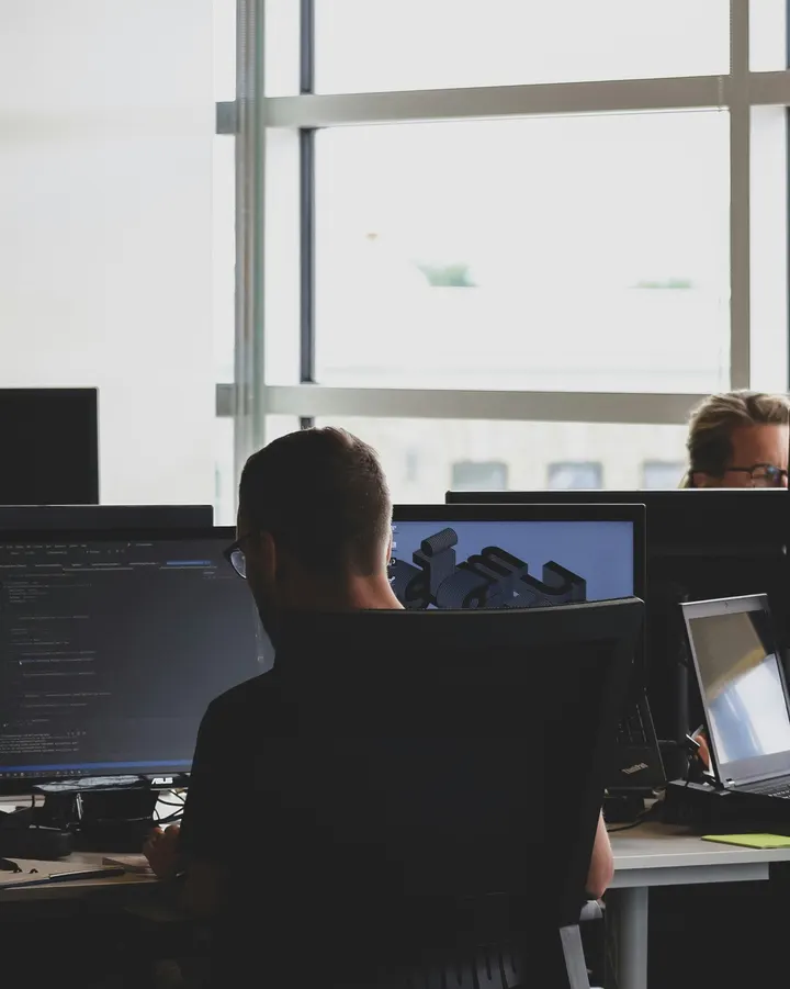 Team working at screens in an open-plan office
