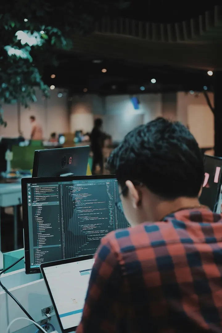 Developer working on two screens